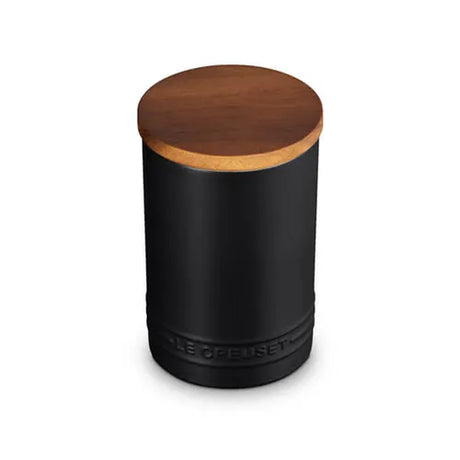 Black cylindrical container with a wooden lid on a white background