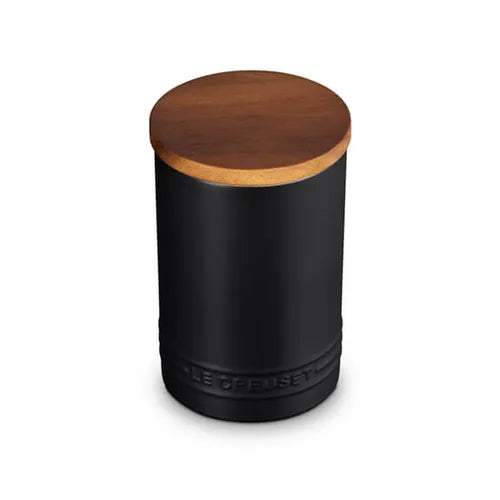 Black cylindrical container with a wooden lid on a white background
