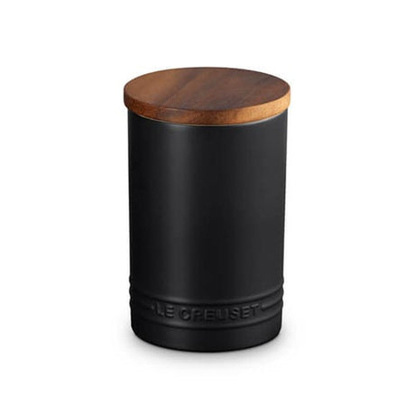 Black storage jar with a wooden lid on a white background