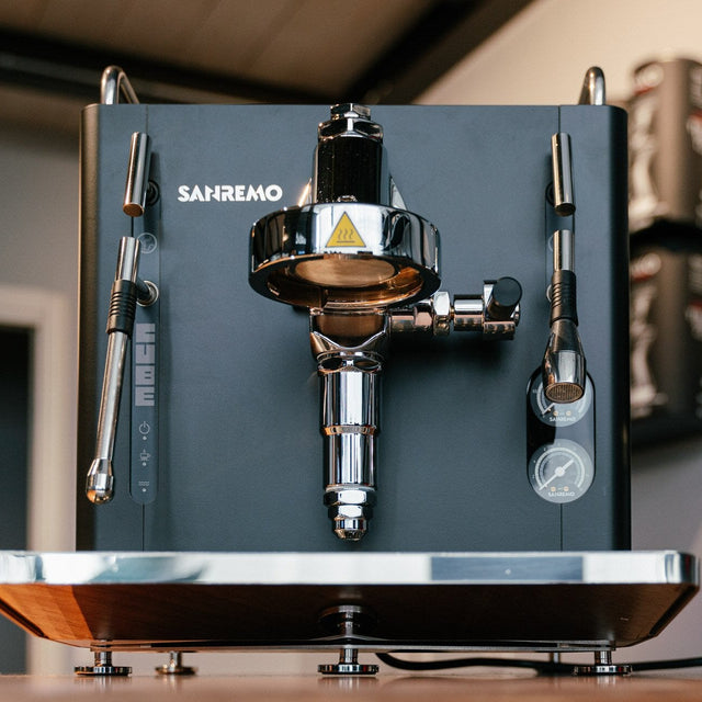 Espresso machine with a coffee grinder on a wooden surface