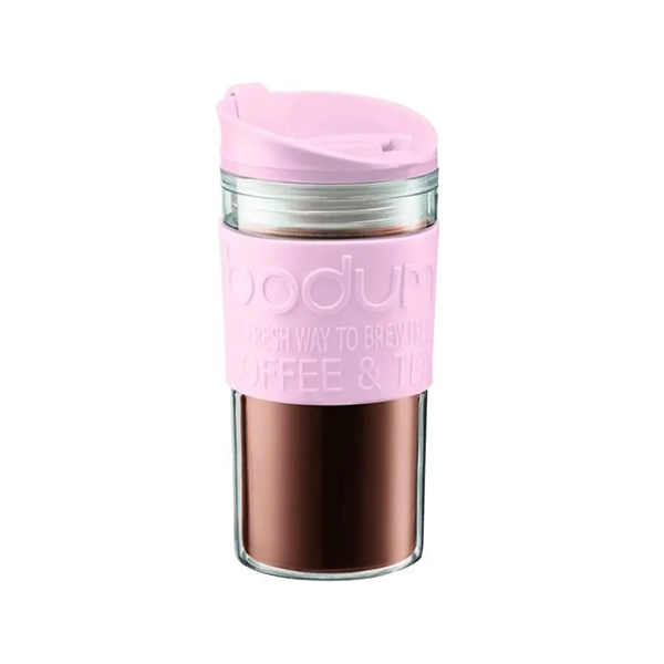 Pink travel mug with a clear lid on a white background