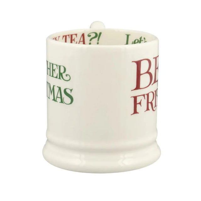 White mug with text in green and red on a white background