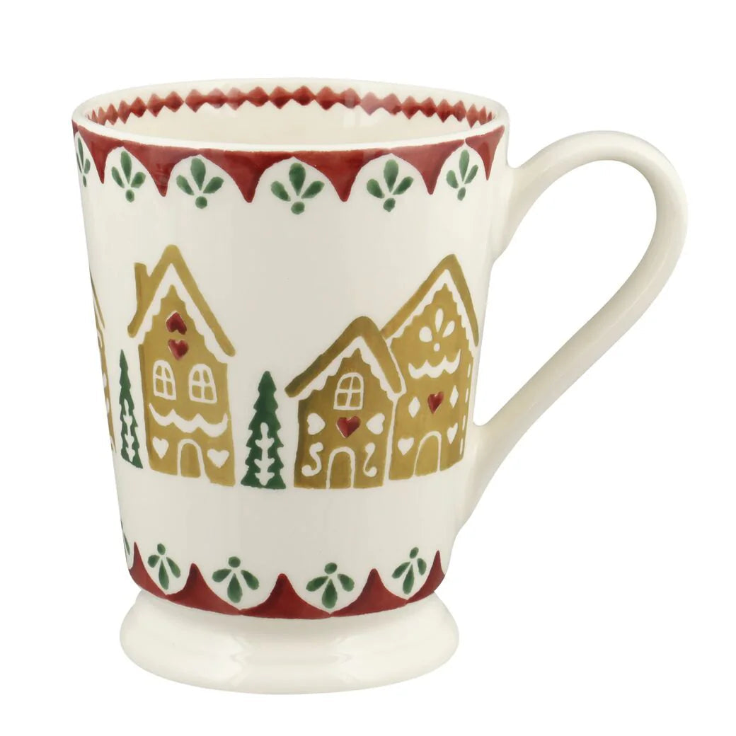 Ceramic mug with gingerbread house design on a white background