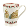 Ceramic mug with gingerbread house design on a white background