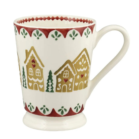 Ceramic mug with gingerbread house design on a white background