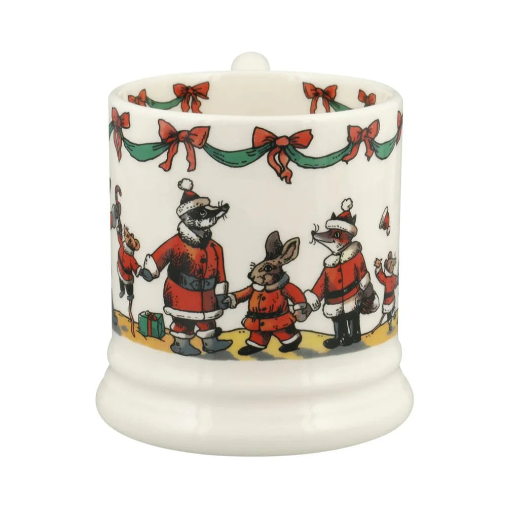 Decorative candle with festive design of animals in Santa outfits on a white background