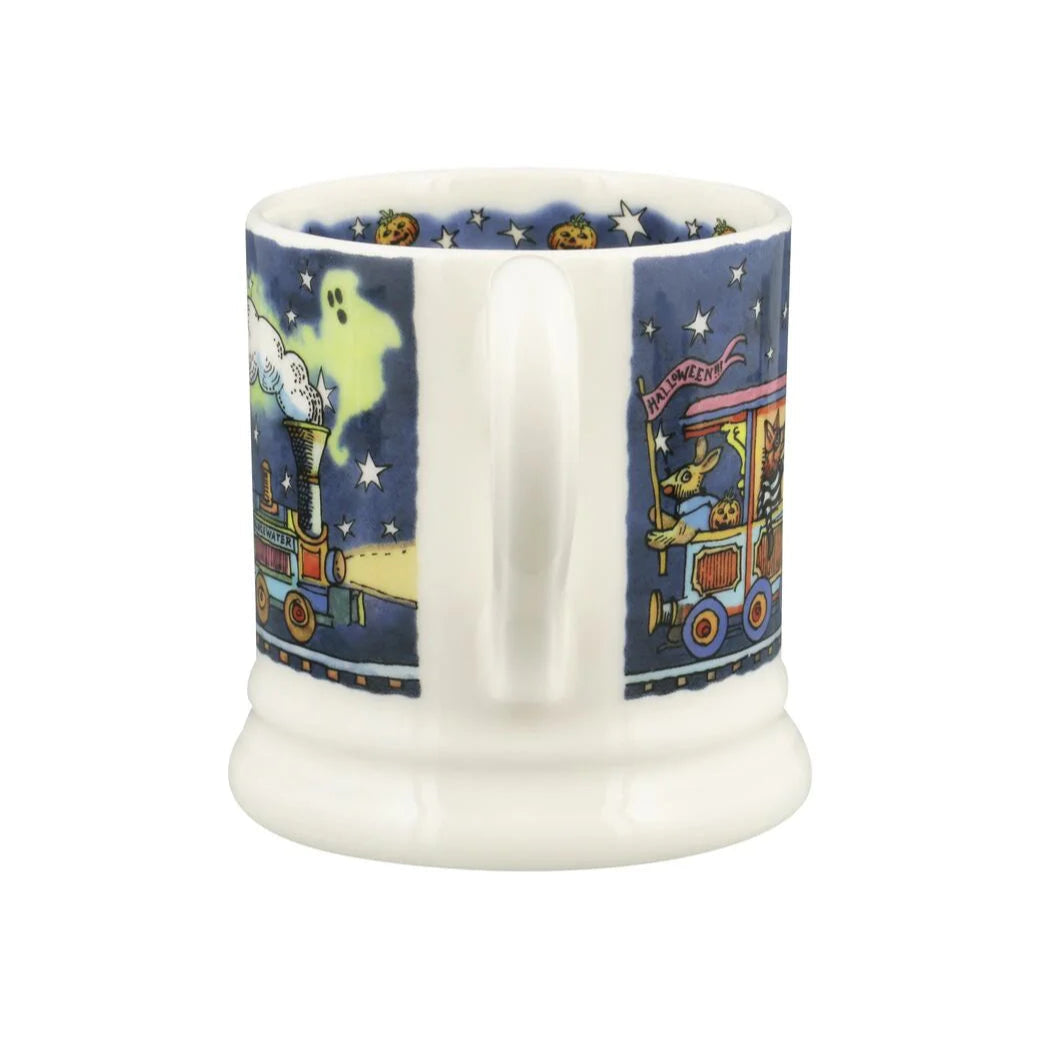Ceramic mug with a colorful train design on a blue background
