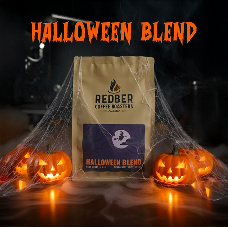 Redber Coffee Roasters Halloween Blend coffee bag with pumpkins and cobwebs on a dark background
