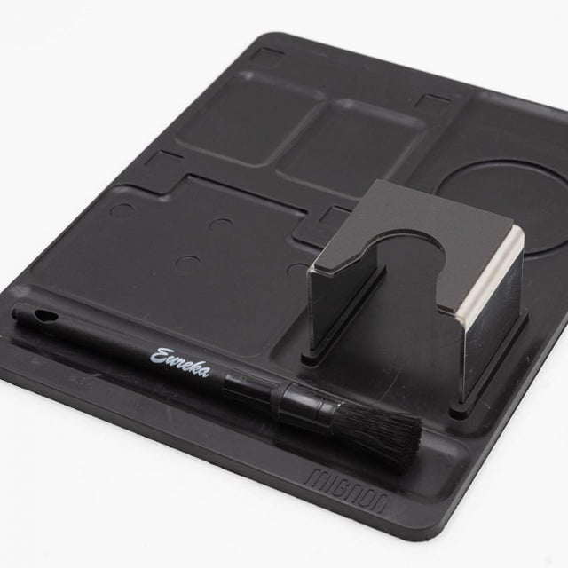 Black knife sharpener with a brush on a white background