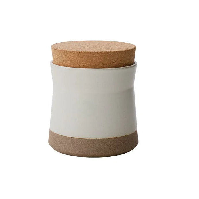 Kinto white storage container with cork lid and base on a white background