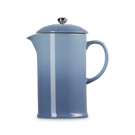 Blue French press coffee maker on a white background