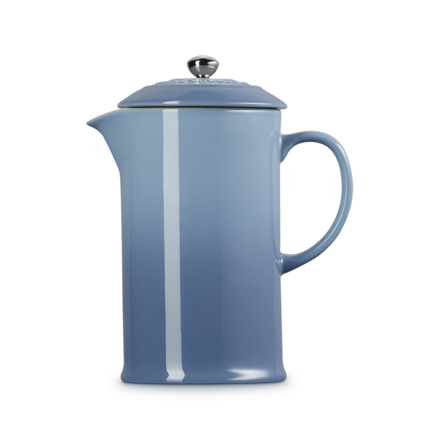Blue French press coffee maker on a white background