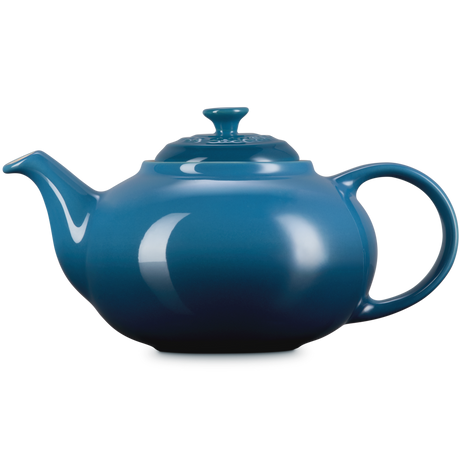Blue teapot on a white background