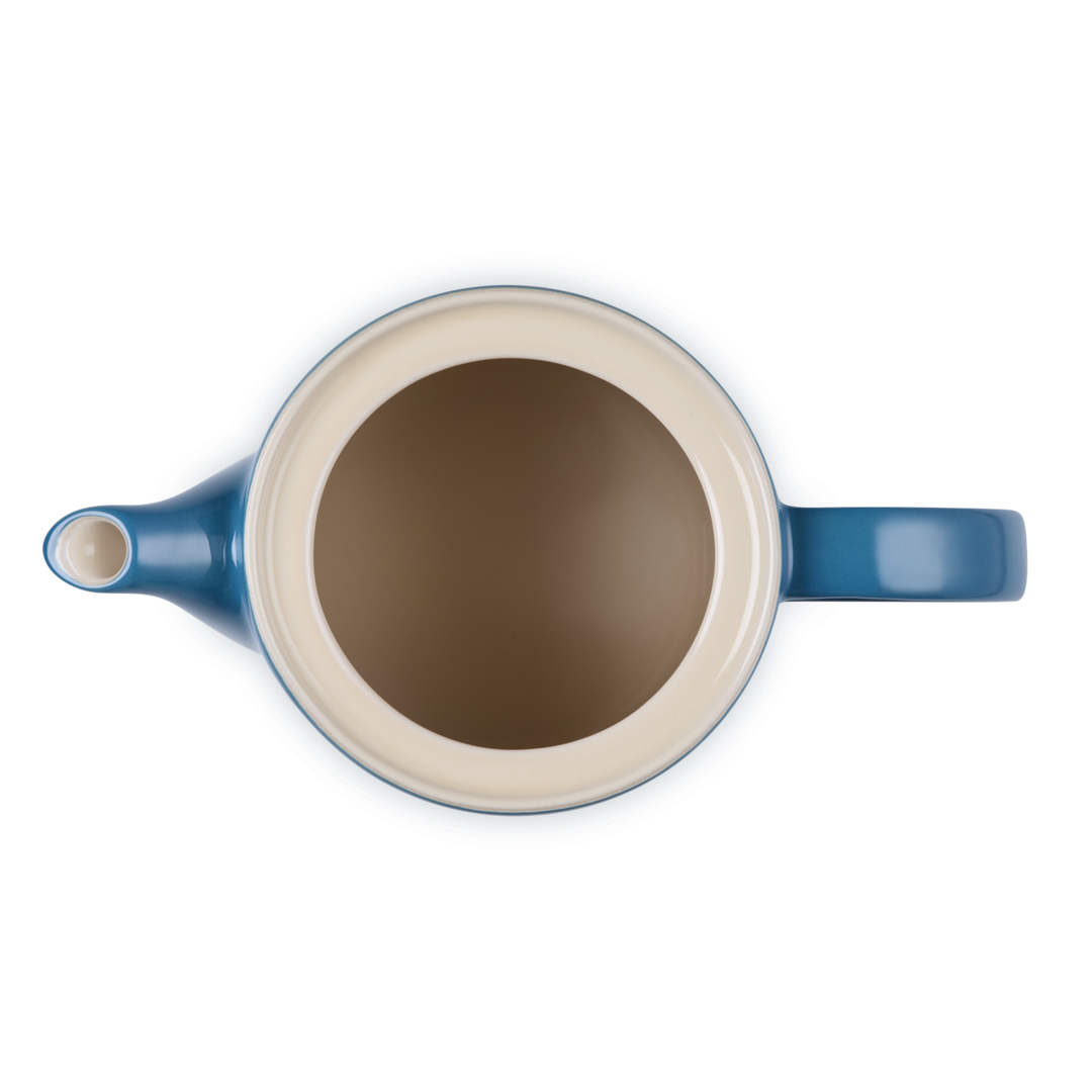 Blue and beige teapot on a white background