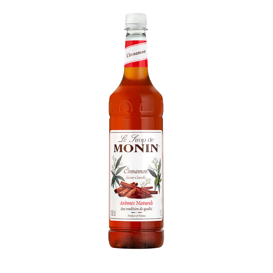 A bottle of Monin Coffee Syrup with cinnamon roll flavor, 1 liter size.