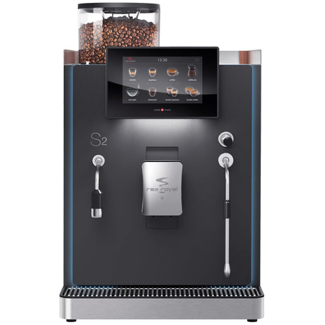 Rex-Royal S2 bean-to-cup coffee machine, designed for cafΓ©s, restaurants, and offices. Compact and Swiss-engineered, it features a 7-inch touchscreen, advanced milk system, and automated cleaning. Customisable with payment solutions and cup dispensers, delivering barista-quality coffee efficiently in high-demand environments.