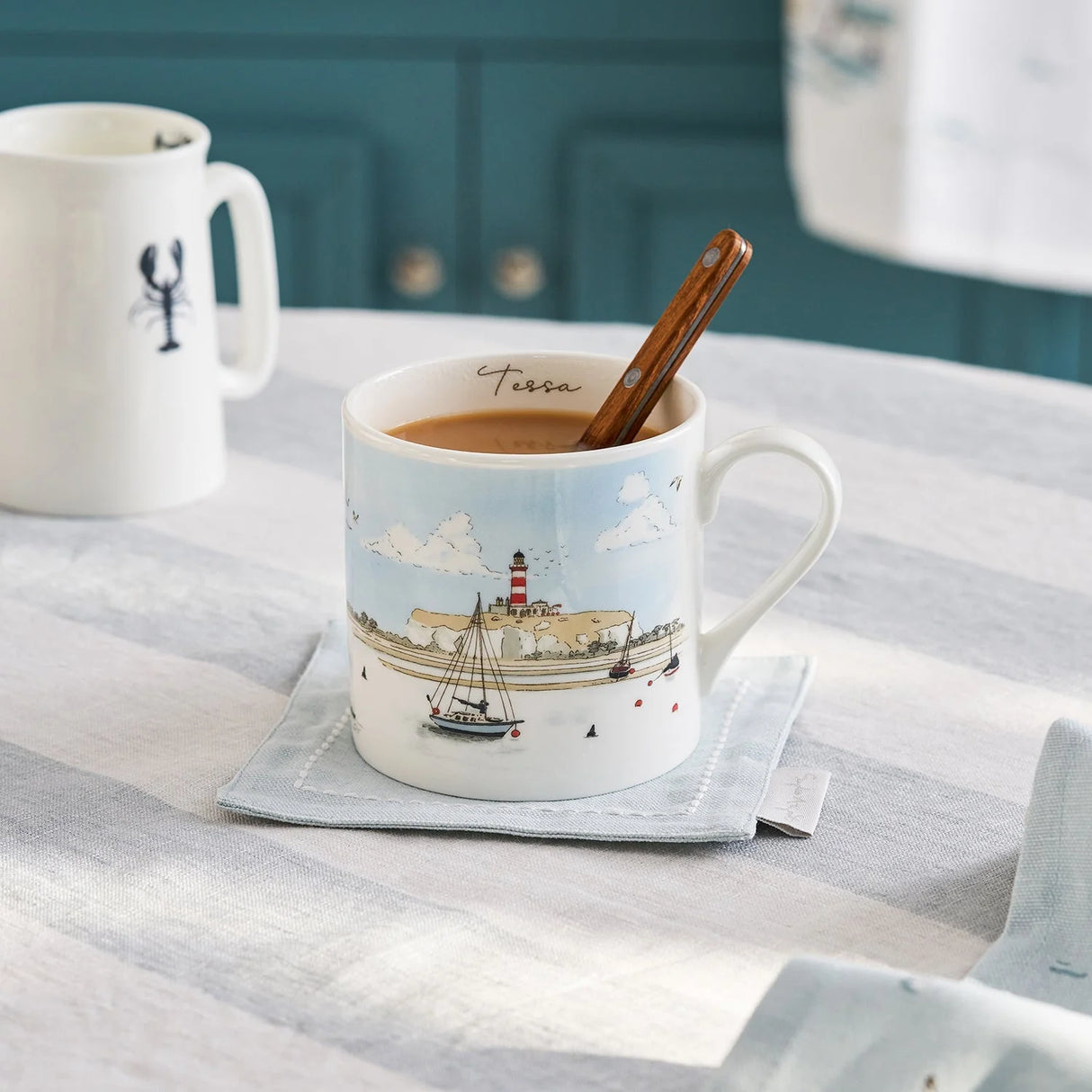 Mug with a lighthouse design filled with coffee on a table.