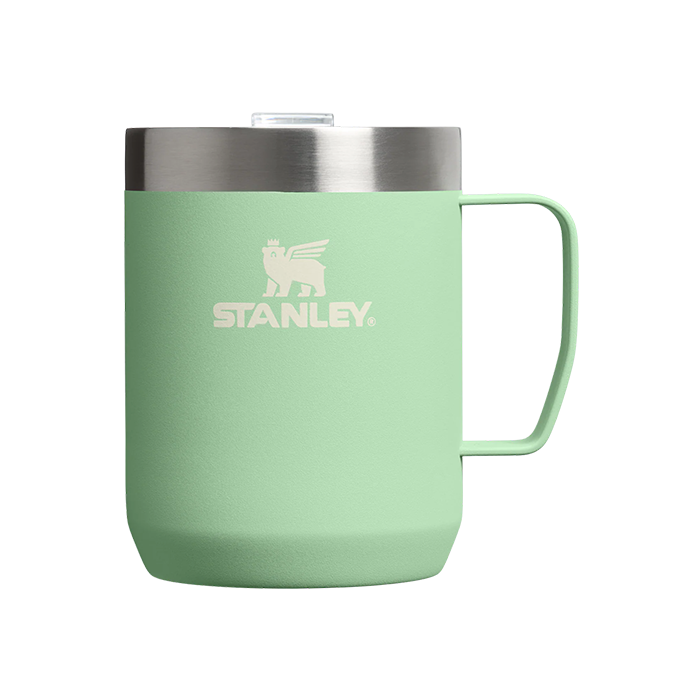 Green Stanley mug with a silver lid on a white background