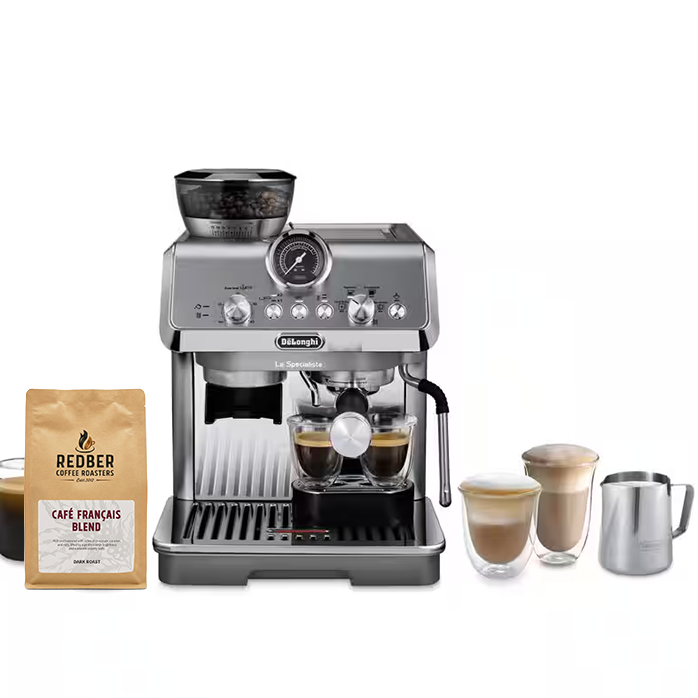 A silver De'Longhi espresso machine with a bean hopper, shown with a bag of Redber Café Français Blend coffee, a glass cup of espresso, and three milk-based coffee drinks on a white background.