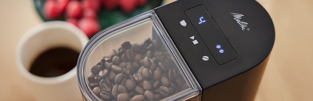 Melitta Linea coffee grinder with coffee beans in a kitchen