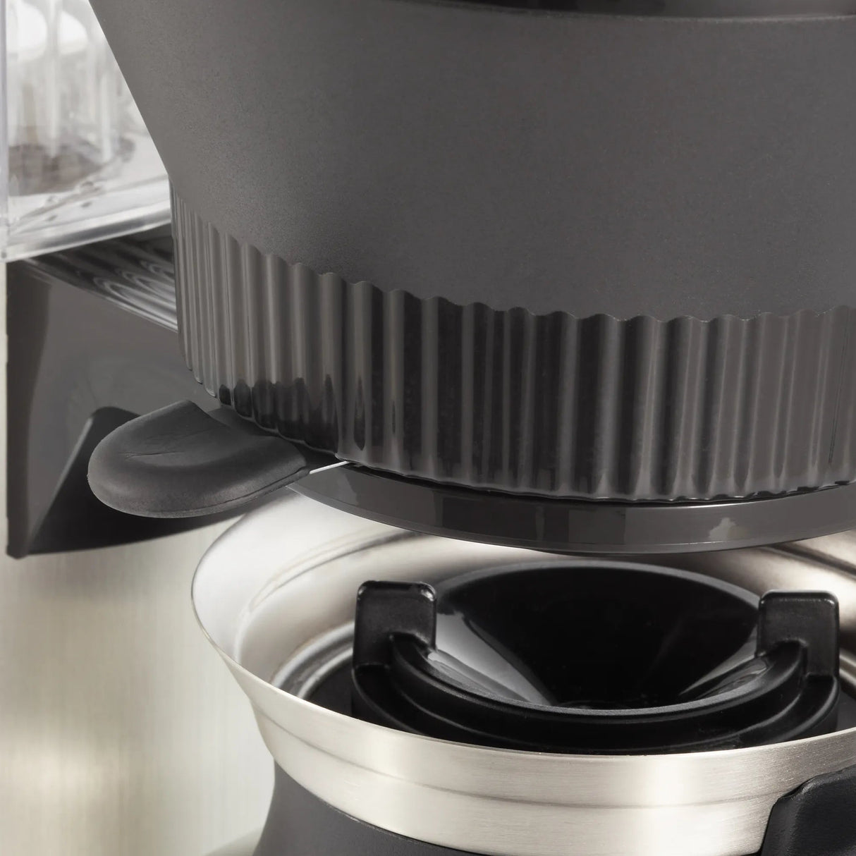 Close-up of a Moccamaster coffee grinder with a focus on the top part.