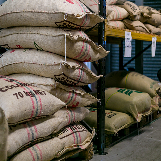 Stack of coffee bags on a pallet in a warehouse setting