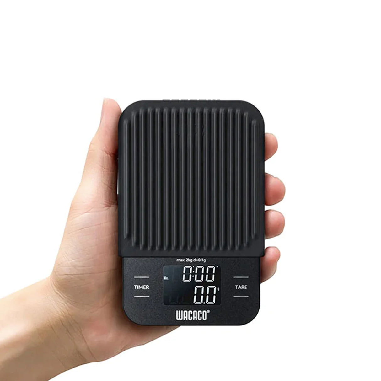 Black digital kitchen scale held in a hand with a white background