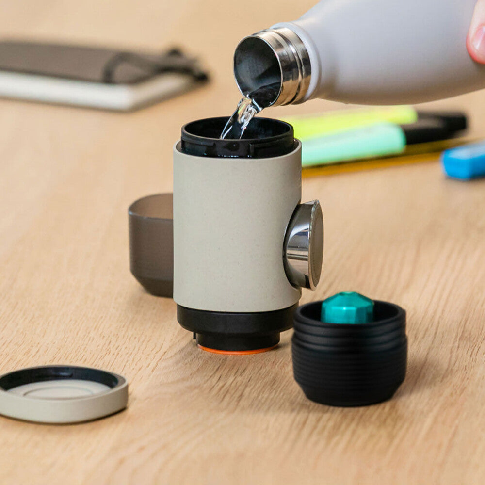 Wacaco Minipresso NS2 and coffee capsules on a desk