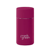 Purple reusable water bottle with 'frank green' branding on a pink background