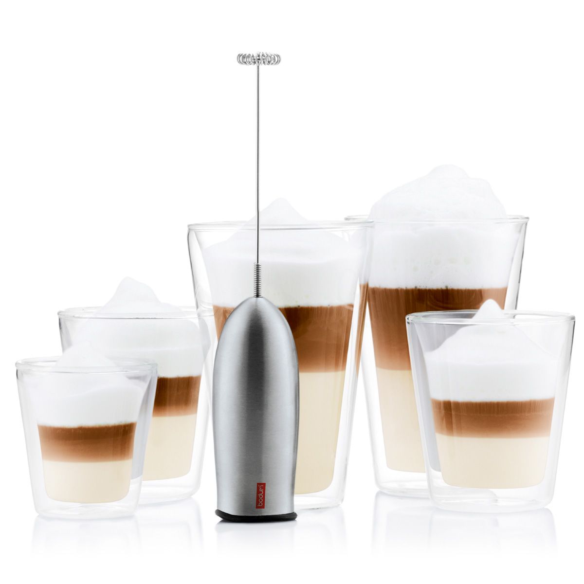 A Bodum SCHIUMA Milk Frother Whisk in stainless steel, with a handheld design and a flexible stainless-steel wand, displayed alongside glasses of frothy beverage.
