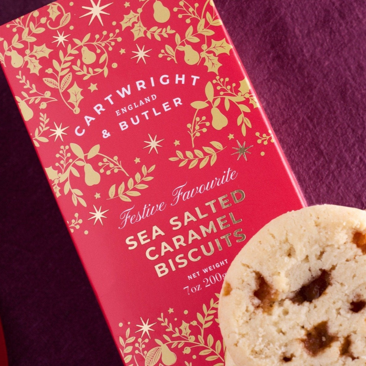 Cartwright & Butler festive sea salted caramel biscuits with a decorative box on a purple background
