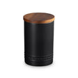 Black storage jar with a wooden lid on a white background