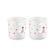 Le Creuset Stoneware Set of 2 Heart Mugs 350ml Two white ceramic cups with heart patterns on a white background