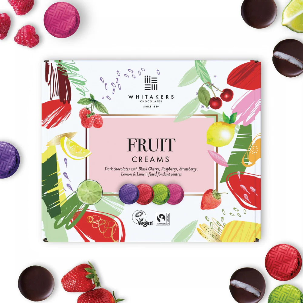 Whitaker's Fruit Creams chocolate box with various fruit-themed chocolates around it.