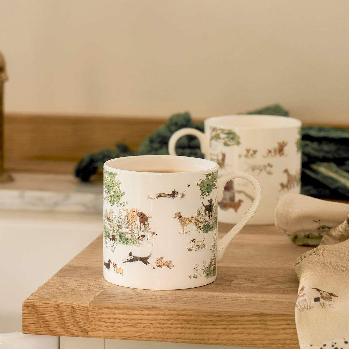 Sophie Allport Tails & Trails mugs on a wooden board in a kitchen setting