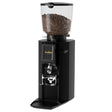 Black coffee grinder with coffee beans on a white background
