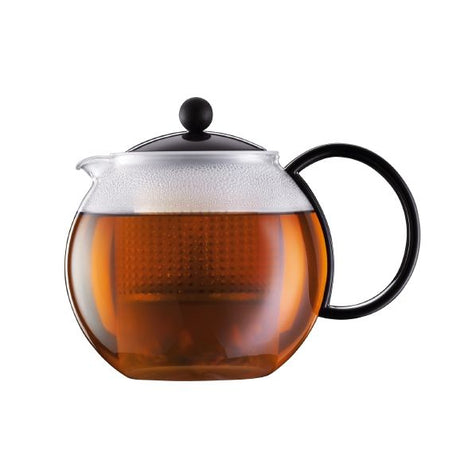 Teapot with black handle and lid on a white background