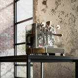 Espresso machine on a table with a rustic wall background