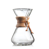 Clear glass coffee maker with wooden collar on a white background