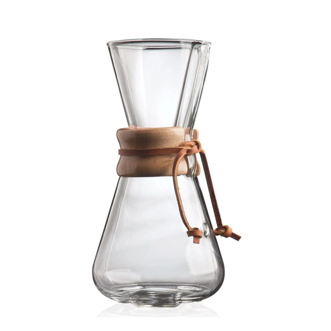 Clear glass coffee maker with a brown leather strap on a white background