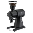 Black coffee grinder with a clear container of coffee beans on a white background