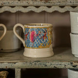 Decorative mug with colorful patterns on a rustic shelf