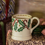 Decorative ceramic mug with Christmas designs on a patterned surface