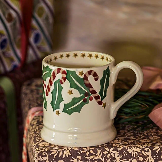 Decorative ceramic mug with Christmas designs on a patterned surface