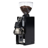 Black coffee grinder with glass container of coffee beans on a white background