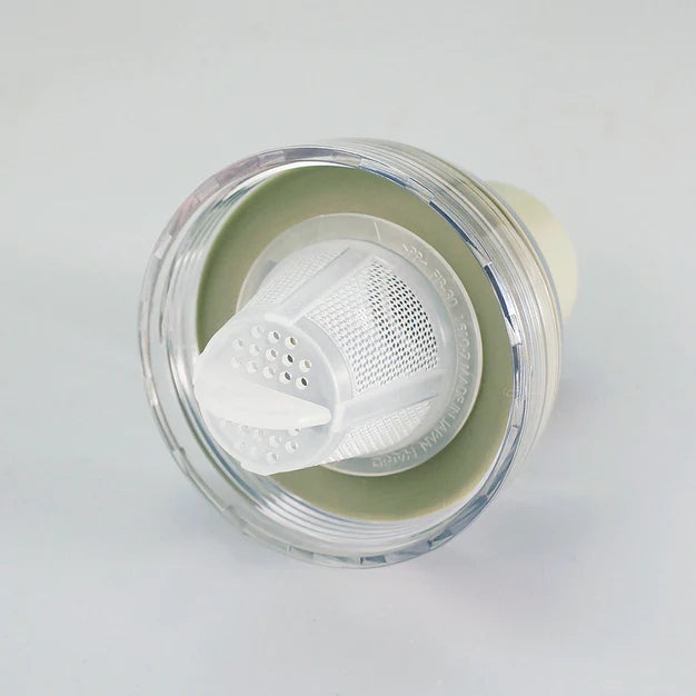 Clear plastic container with a white mesh filter on a light gray background