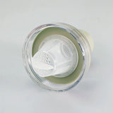 Clear plastic container with a white mesh filter on a light gray background
