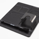 Black knife sharpener with a brush on a white background