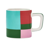 Color-blocked mug with a white handle on a white background