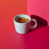 White coffee cup with a yellow and red background